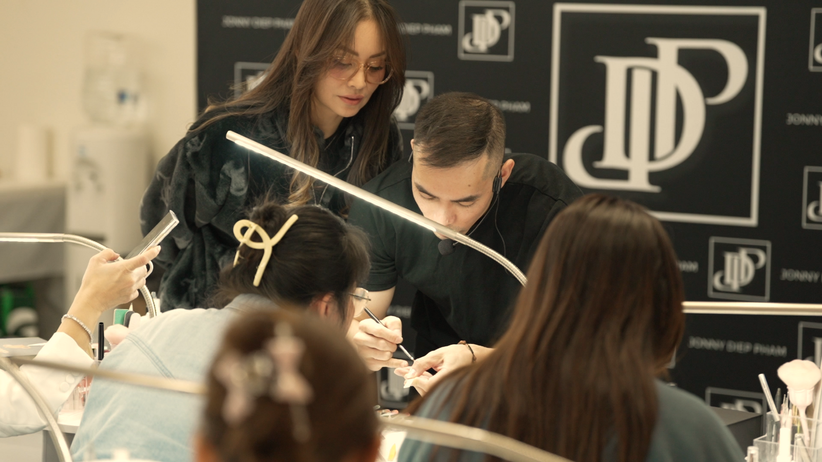 Jonny from JDP guiding students during a nail training class