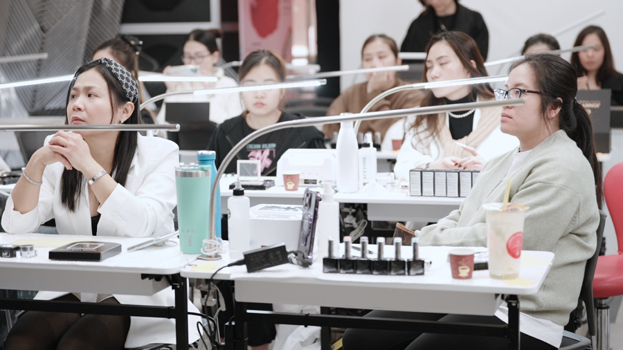 JDP trainer guiding nail students